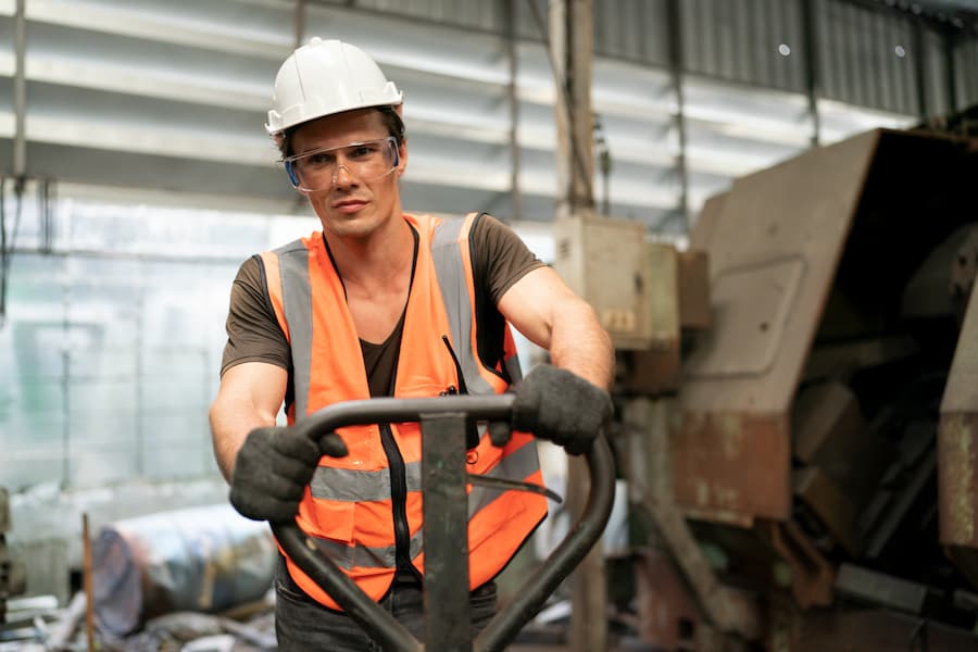 Factory Worker Moving Materials with Hand Truck