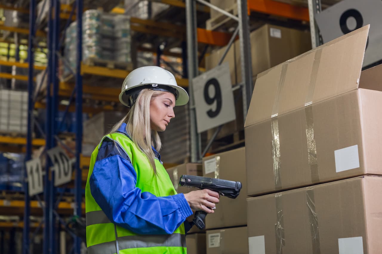 Female warehouse worker using scanner