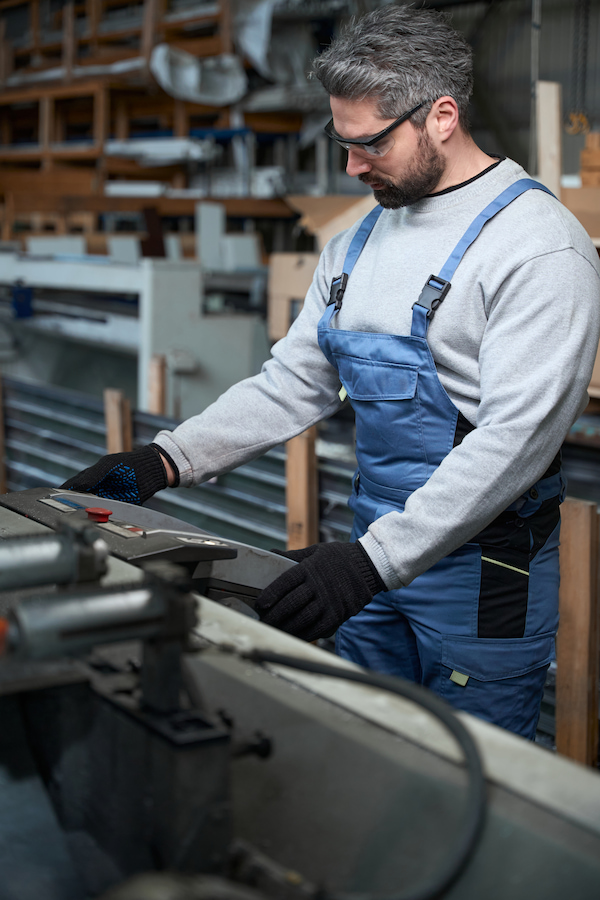 Man operating machine in a Brisbane production workshop