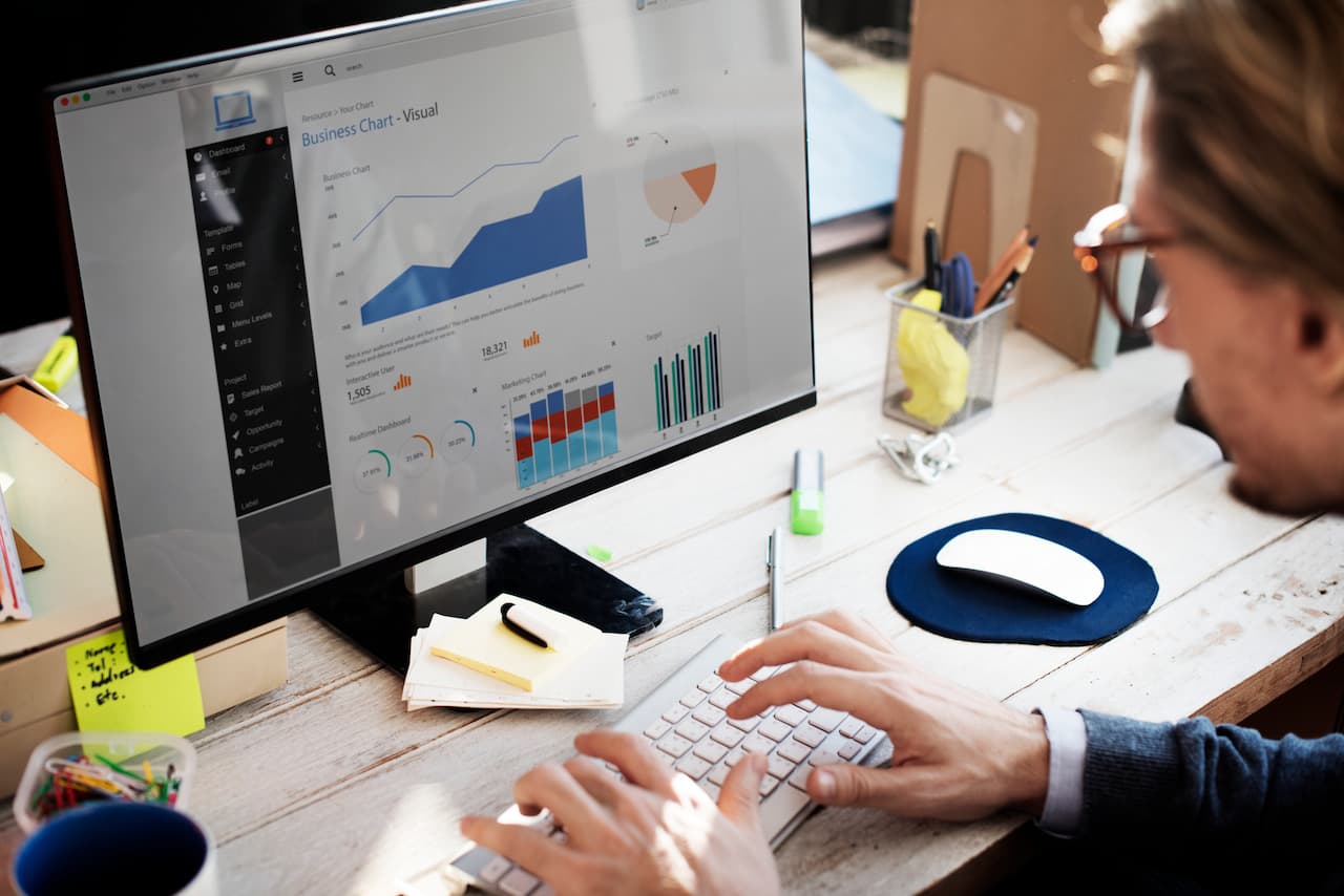 SEO specialist reviews charts on computer