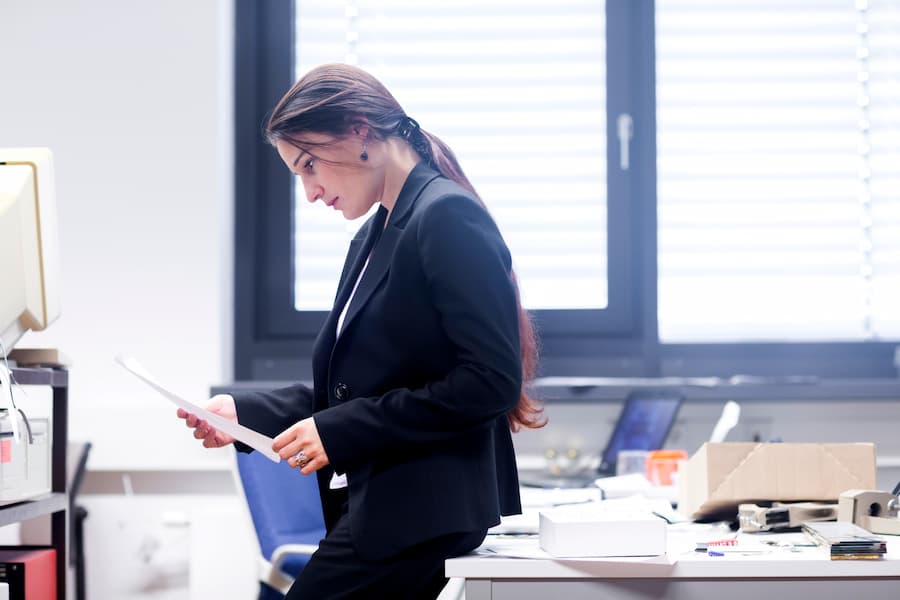 Side view of a female recruiter looking at paperwork in modern office