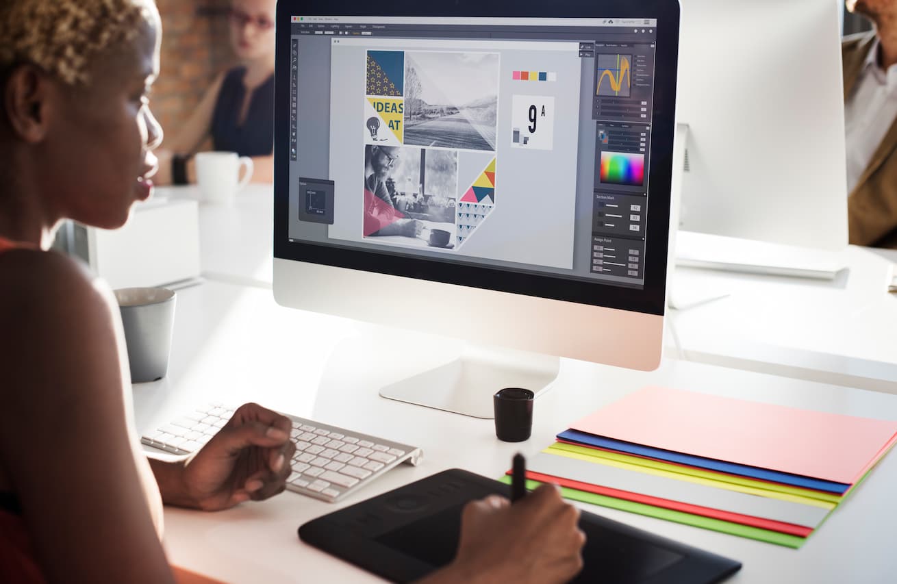Female Graphic Design Works Creatively in Workplace Setting