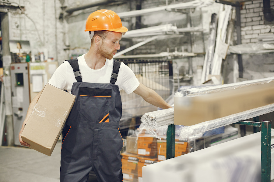 Factory labourer moving material in Brisbane workshop