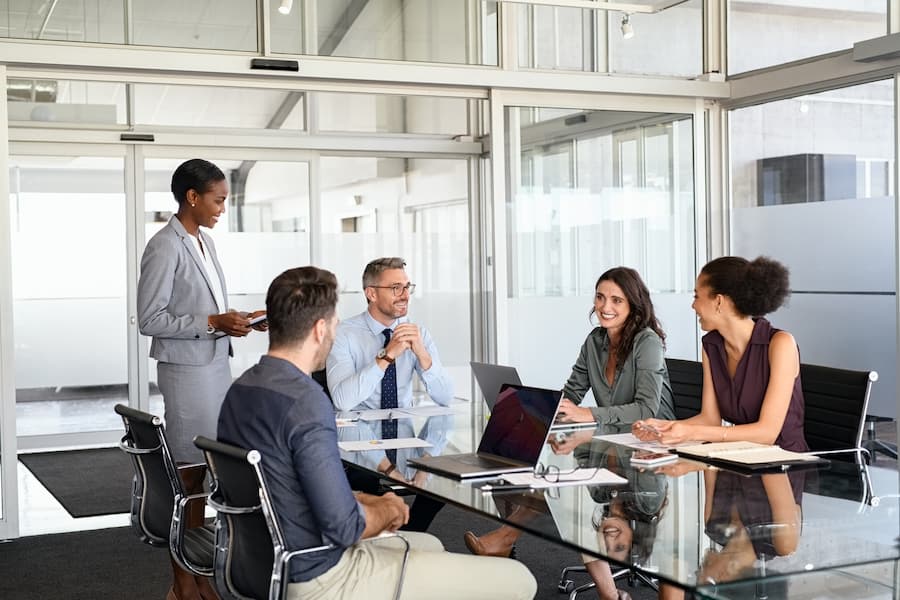 A sales team discuss business ideas in a modern office