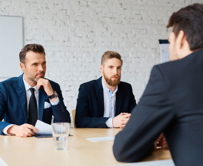 Men in suits conducting a job interview