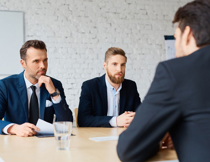 two men interviewing a professional candidate